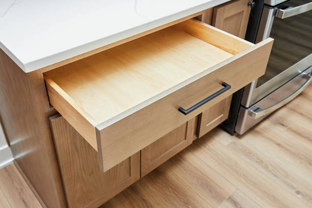 A clean and empty wooden kitchen drawer, illustrating the result after effective cabinet cleaning methods.