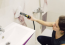 Using a steam cleaner to sanitize and remove grime from bathroom tiles
